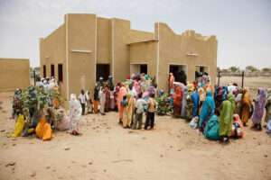 People wait for vaccination outside a hospital in Sudan