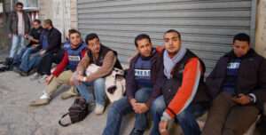 Journalists sitting on the ground
